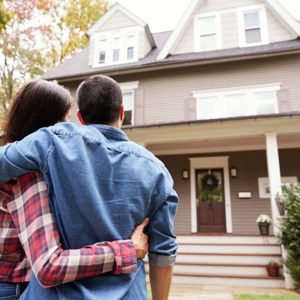 couple in front of new home