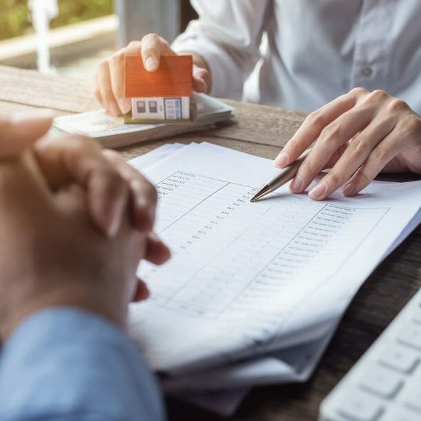 Woman Going Over Paperwork With Client