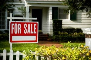 House with For Sale Sign in Front Yard