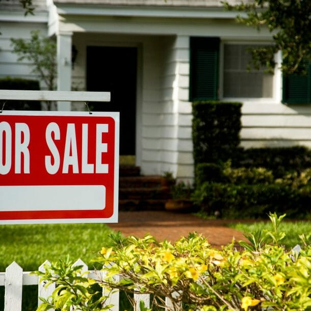 House with For Sale Sign in Front Yard